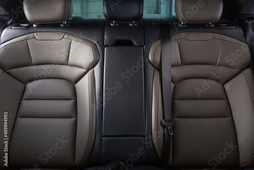 Luxury car rear seats row. Expensive car leather seats, view from the front seats. © Moose