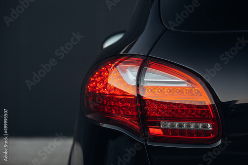 Modern car rear taillight lamp close up view. Clean trunk of modern SUV car