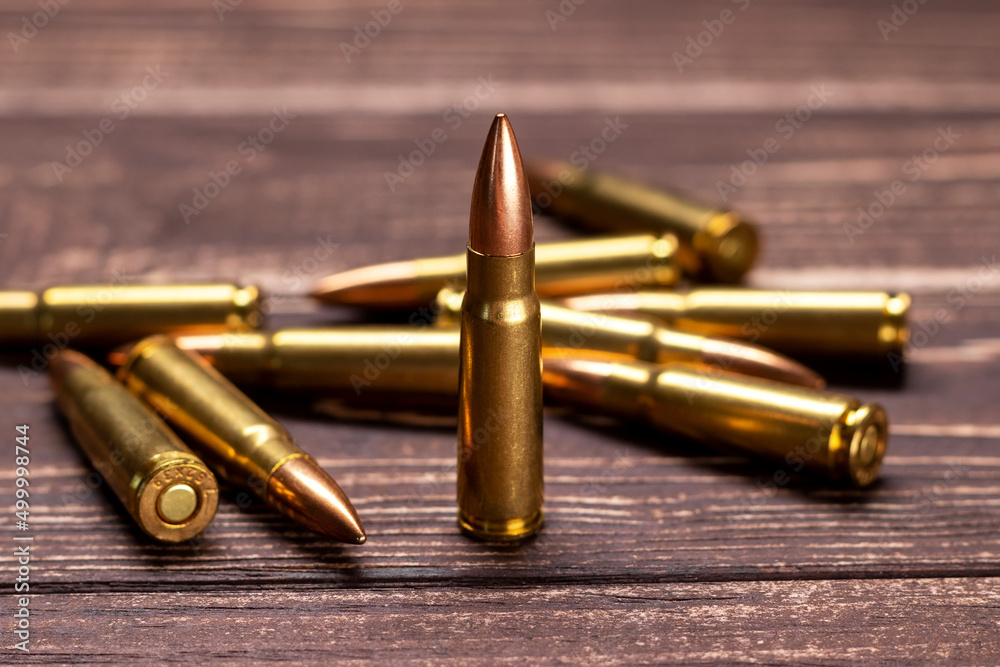 Bullets on wooden background. Cartridges 7.62 caliber for ak 47 closeup. Selective focus Bullets on wooden background. Cartridges 7.62 caliber for ak 47 closeup. Selective focus