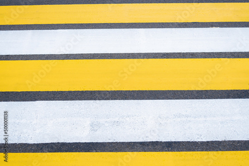 Free Download Yellow-white pedestrian crossing on asphalt. Close-up of the road. - GFXLoad