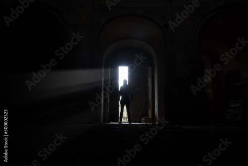 Man hiding in dark  terrifying background for cover of book. Crime or horror.