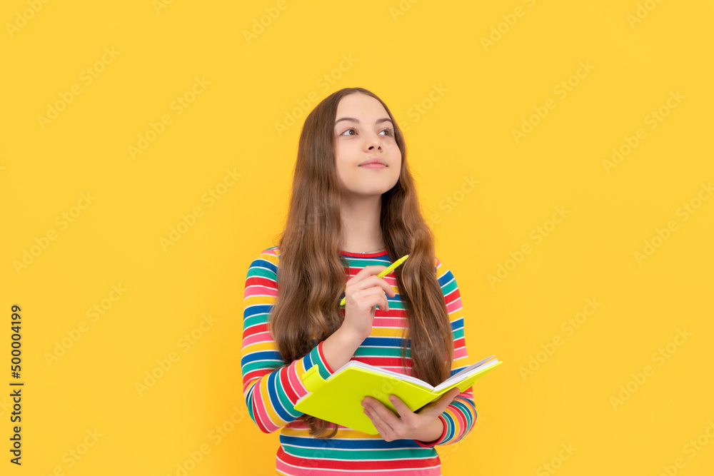 Think before writing. Child think holding copybook and pen. Thoughtful girl yellow background Think before writing. Child think holding copybook and pen. Thoughtful girl yellow background