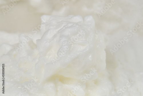 Background of beaten eggs or whipping egg whites to soft peaks. Whipping cream with a whisk. Process of cooking meringue. Shallow depth of field