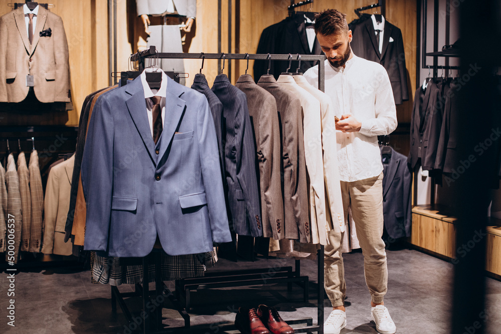 Man scanning qr code with price at mens store Man scanning qr code with price at mens store