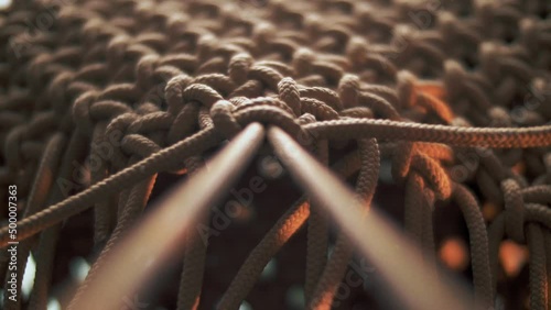 Strong tightening of a knot on a rope with weaving photo