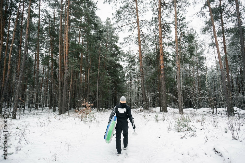 surfer in the winter forest