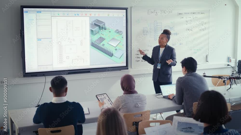Black Female Teacher Using Digital Interactive Screen,Talk to Group of Diverse Students and Showing 3D Circuit Board Components. Education and High Tech Concept