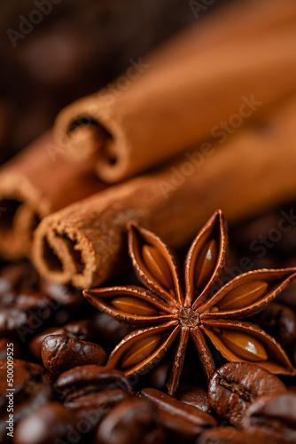 Roasted coffee beans and spices background. Macro shot