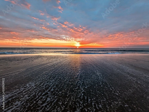 Leinwand Poster Beautiful sunrise sunset orange red background in the outer Banks of North Carol