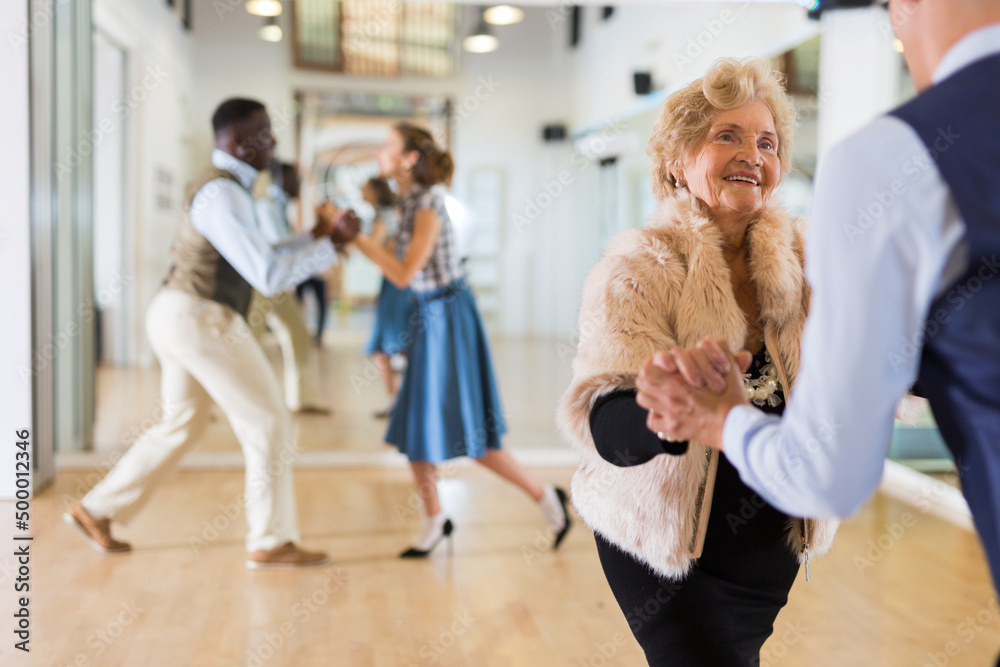 Mature woman at a group training in studio of dance Mature woman at a group training in studio of dance