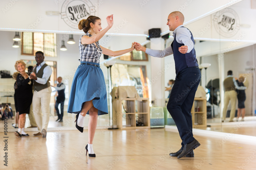 Pair dancing lindy hop during rehearsal Pair dancing lindy hop during rehearsal