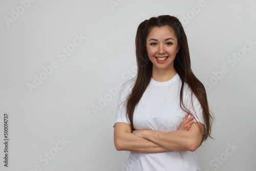Smiling woman pointing up on white background