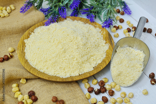 Wooden spoons of various gluten free flour (almond flour, amaranth seeds flour, buckwheat flour, rice flour, chick peas flour) from top view photo