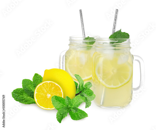 Mason jars with tasty lemonade, fresh ripe fruits and mint on white background photo