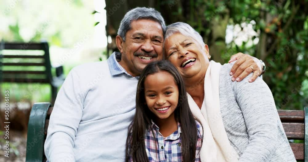 The greatest source of happiness comes from family. Grandparents bonding with their little granddaughter at the park.Foster parents out with their foster child. Mature couple meeting their adopted kid The greatest source of happiness comes from family. Grandparents bonding with their little granddaughter at the park.Foster parents out with their foster child. Mature couple meeting their adopted kid