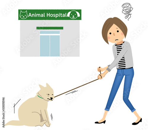 若い女性と病院へ行くのを嫌がる犬