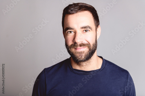 portrait of casual young man with beard white background