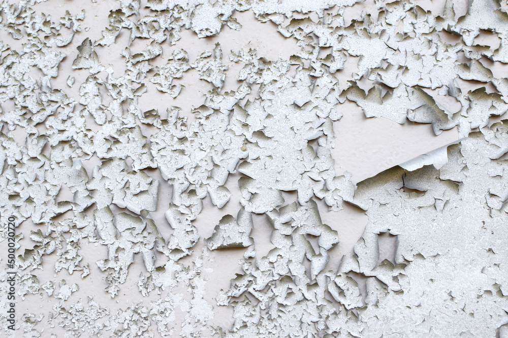 Old gray paint peeling from wall texture background. Cracked paint on metallic background Old gray paint peeling from wall texture background. Cracked paint on metallic background