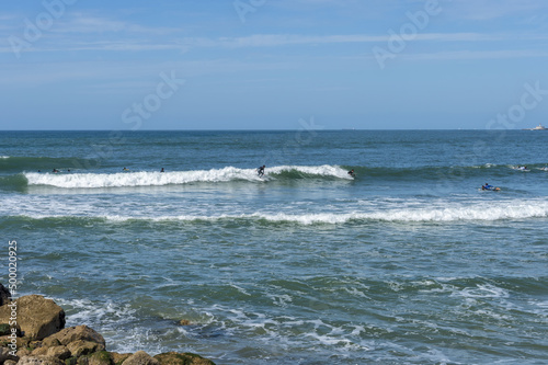 Surfers at Costa da Caparica beach, Setubal Province, Portugal