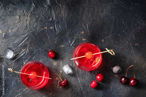 Canvastavla Cocktail with cherry and ice, an aperitif with a garnish on a dark background wi