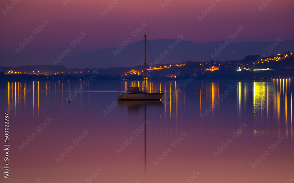 Idyllic evening atmosphere after sunset on Lake Murtensee, Switzerland