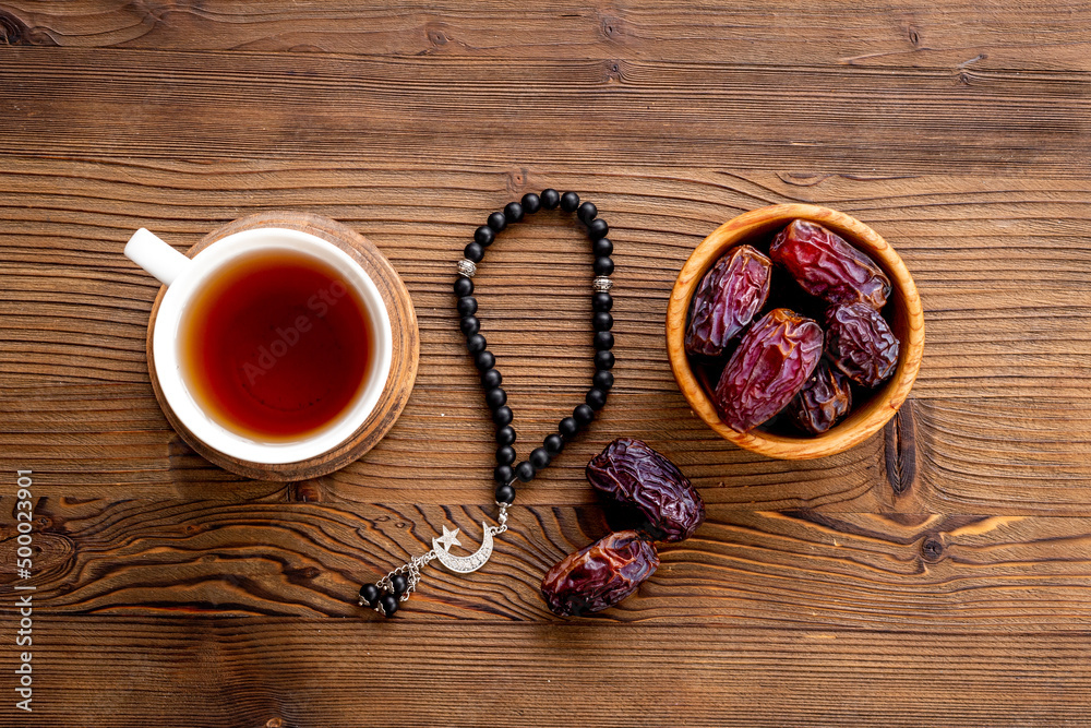 Turkish tea on Ramadan with islamic rosary and dates fruits in bowl