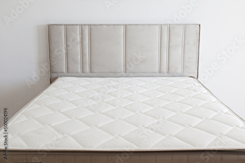 Quadro su tela White orthopedic mattress top side surface pattern on unmade bed in the bedroom