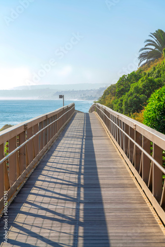 Straight narrow bridge with a view of the blue sea water against the sky in San Clemente, California