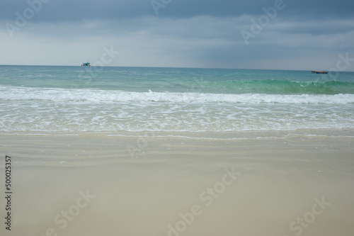 Sea waves blowing on the beautiful sandy beach.