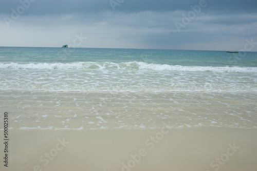 Sea waves blowing on the beautiful sandy beach.