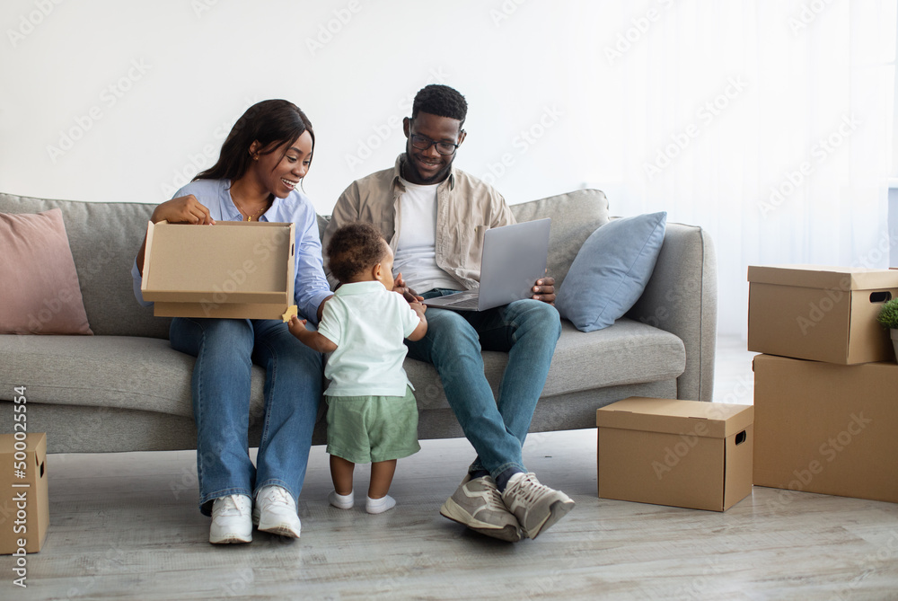 Happy man woman and kid using pc after relocation Happy man woman and kid using pc after relocation