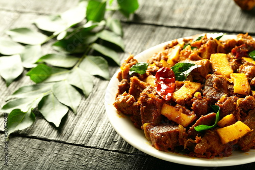 Beef ularthiyathu, Delicious meat fry with exotic spices, Kerala foods background. photo