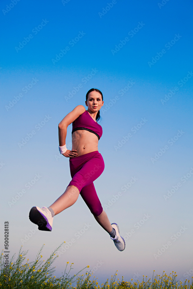 Beautiful young woman jumping in the farm Beautiful young woman jumping in the farm