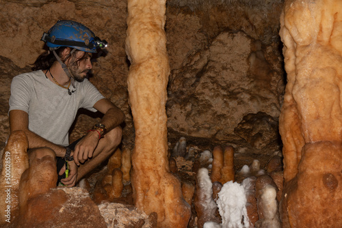 Photography Young tourist in a miner helmet in the large Bellamar caves (Cuevas de Bellamar)