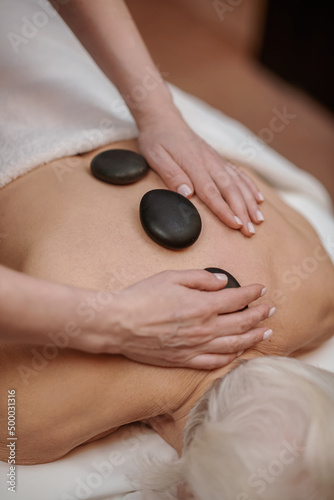 Close up picture of a woman having stone back massage