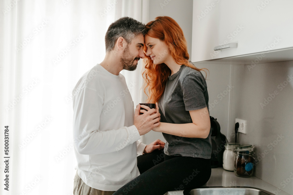 Couple caressing on kitchen counter Couple caressing on kitchen counter