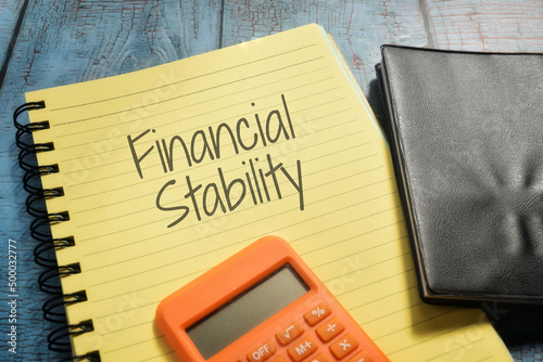Closeup shot of a yellow notebook page with the writing financial stability photo
