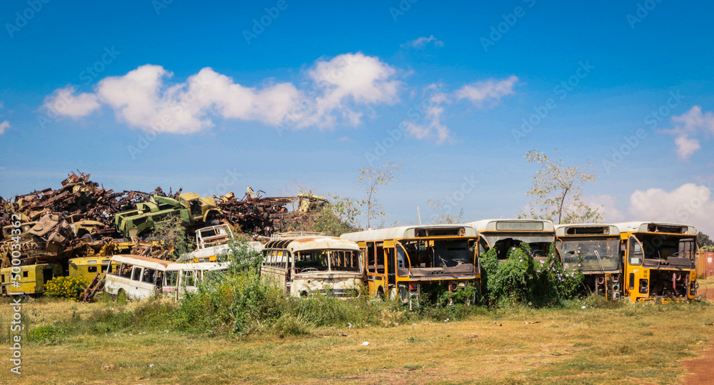 Fototapeta premium Rusted and Crushed Buses on the Tank Graveyard in Asmara, Eritrea