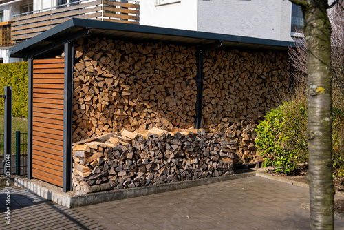 Tableau sur toile Shed in the yard with stacked firewood for the fireplace.