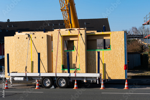 Ready for unloading panels of a wooden prefabricated house. Crane boom at the back. photo