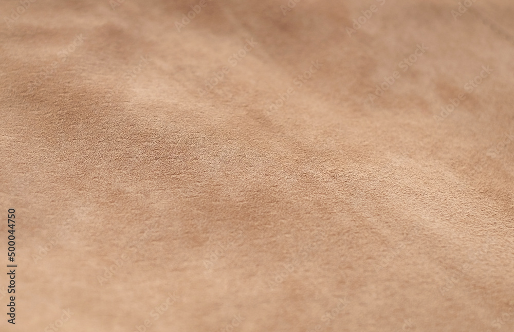 Light suede leather beige matte background top view Light suede leather beige matte background top view