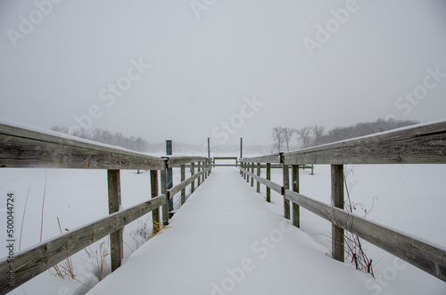 Snowy dock over Hyland Lake, Bloomington, Minnesota photo