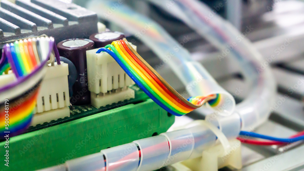 Close up view of the flat rainbow ribbon wire cable connect to terminal block connector. Close up view of the flat rainbow ribbon wire cable connect to terminal block connector.