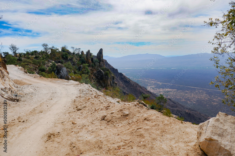 An empty dirt road against the background of Mount Koogh in West Pokot, Kenya An empty dirt road against the background of Mount Koogh in West Pokot, Kenya