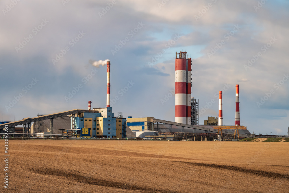 panorama of industrial landscape environmental pollution waste of thermal power plant. Big pipes of chemical industry enterprise plant