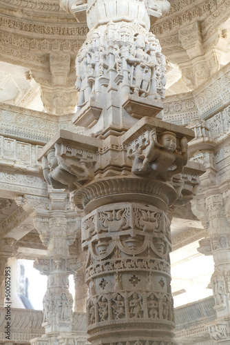 Vertical shot of an intricate sculpted column in the Ranakpur Jain temple in India photo