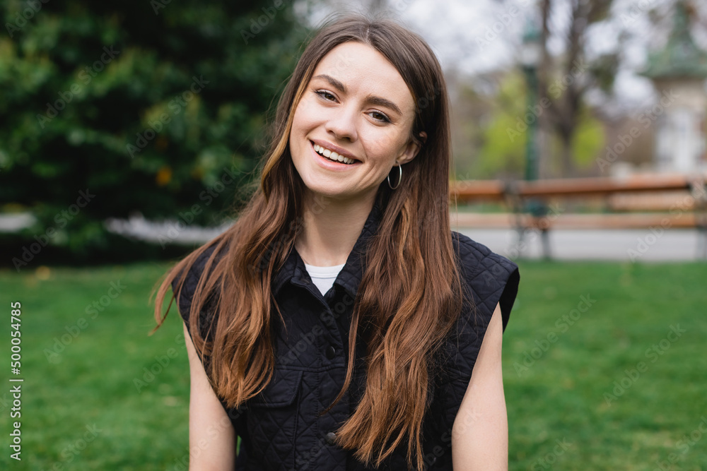 portrait of young cheerful woman in sleeveless jacket. portrait of young cheerful woman in sleeveless jacket.