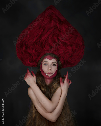 Fashion portrait of a girl in a pink kokoshnik of hair and creative make-up photo
