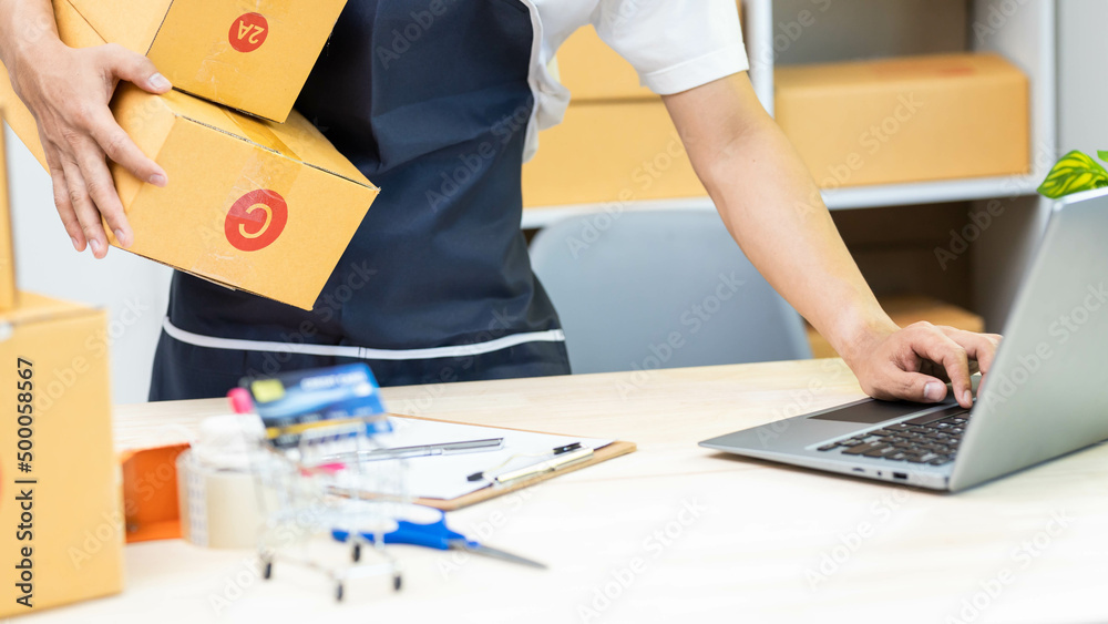 Small business owner delivery service and working packing box, business owner working checking order to confirm before sending customer in post office, Shipment Online Sales. Small business owner delivery service and working packing box, business owner working checking order to confirm before sending customer in post office, Shipment Online Sales.