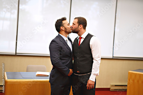 A Handsome gay male couple in the ceremony on their wedding day photo